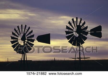Stock Image - Silhouette of two wind turbines. Fotosearch