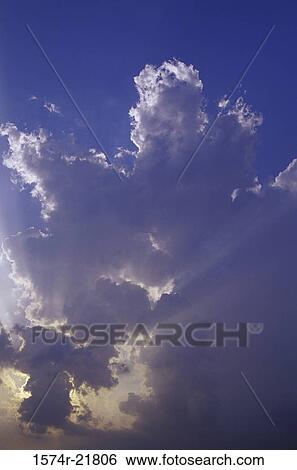 Stock Photograph - Sun shining through clouds. Fotosearch