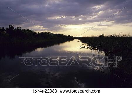 Sunrise over a lake View Large Photo Image Stock Image - Sunrise over a lake. Fotosearch