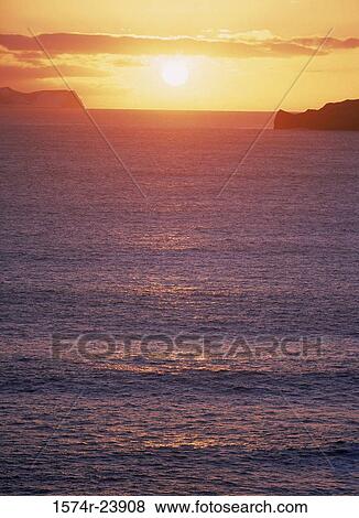 Stock Photo - Sunrise over the sea, Vestmannaeyjar, Iceland. Fotosearch
