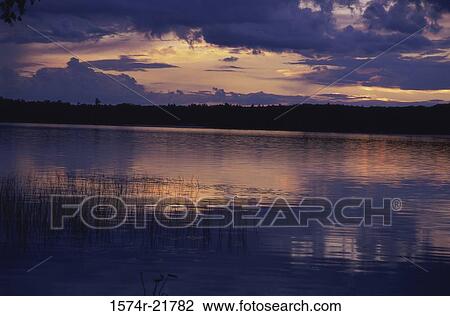 Sunset over a lake View Large Photo Image Stock Image - Sunset over a lake. Fotosearch