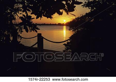Sunset over a lake View Large Photo Image Stock Image - Sunset over a lake. Fotosearch
