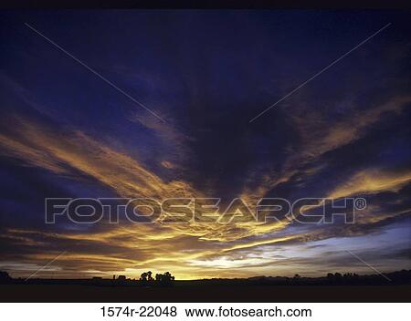 Stock Photo - Sunset over a landscape. Fotosearch