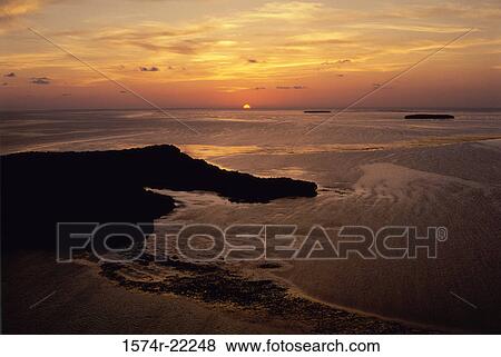 Stock Photo - Sunset over the ocean. Fotosearch