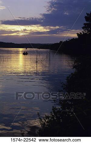 Stock Image - Sunset over water. Fotosearch