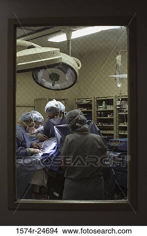 Surgeons operating in an operating room View Large Photo Image Picture - Surgeons operating in an operating room. Fotosearch