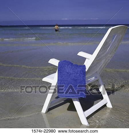 Towel on a deck chair at the beach View Large Photo Image Stock Image - Towel on a deck chair at the beach. Fotosearch