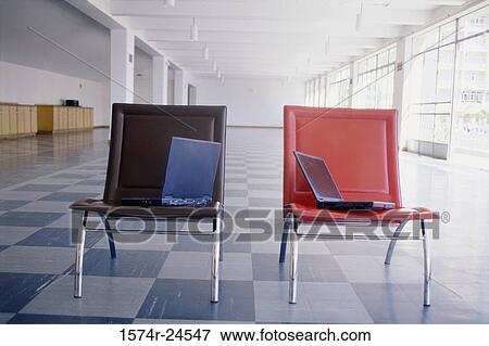 Stock Photo - Two laptops in two chairs. Fotosearch