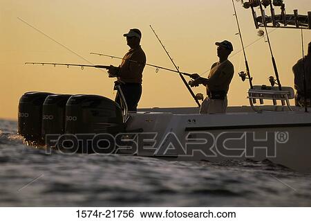Two people fishing on a boat View Large Photo Image Stock Photograph - Two people fishing on a boat. Fotosearch