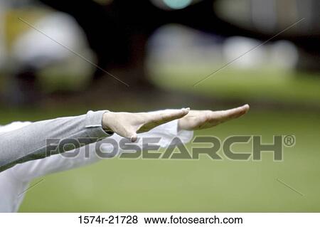 Stock Photo - Two people stretching their arms out. Fotosearch