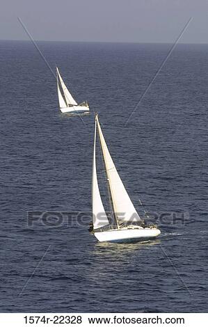 Two sailboats in the sea View Large Photo Image Stock Photo - Two sailboats in the sea. Fotosearch