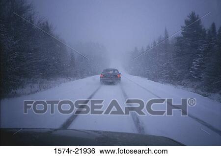 Vehicle on a snow covered road View Large Photo Image Stock Photograph - Vehicle on a snow covered road. Fotosearch