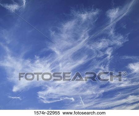 Wispy clouds in a blue sky View Large Photo Image Stock Photography - Wispy clouds in a blue sky. Fotosearch