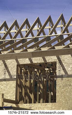 Stock Image - Wooden framework of a house under construction. Fotosearch