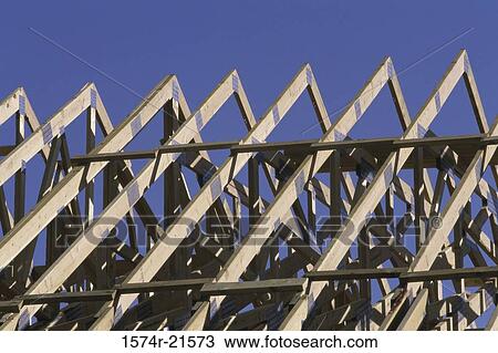 Stock Image - Wooden framework of a roof of a house under construction. Fotosearch
