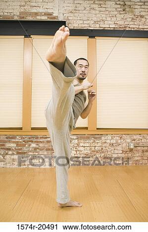 Young man practicing martial arts View Large Photo Image Stock Image - Young man practicing martial arts. Fotosearch