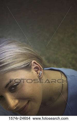 Young woman looking up smiling View Large Photo Image Picture - Young woman looking up smiling. Fotosearch