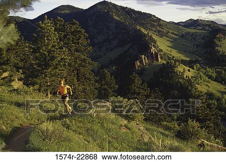 Stock Photo - Young woman running on a trail at Flagstaff Mountain, Boulder, Colorado, USA. Fotosearch