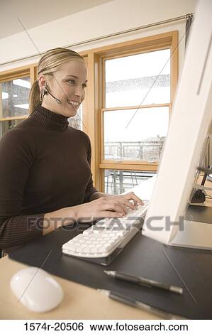 Stock Photograph - Young woman using a computer. Fotosearch