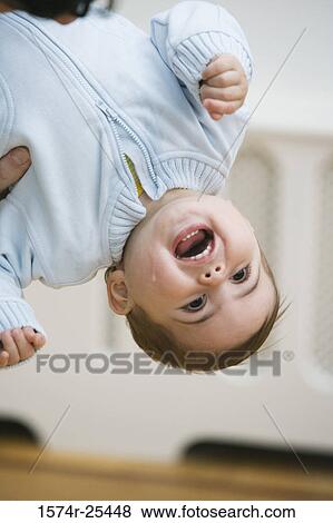 Baby boy hanging upside down View Large Photo Image Stock Photo - Baby boy hanging upside down. Fotosearch