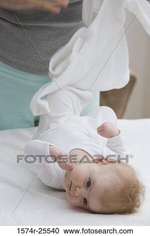 Baby lying on her back View Large Photo Image Stock Image - Baby lying on her back. Fotosearch