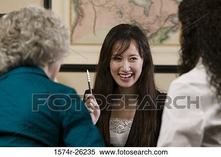 Businesswoman holding a pen and smiling View Large Photo Image Stock Photography - Businesswoman holding a pen and smiling. Fotosearch