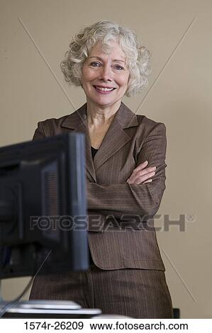 Stock Photo - Businesswoman standing with her arms crossed. Fotosearch