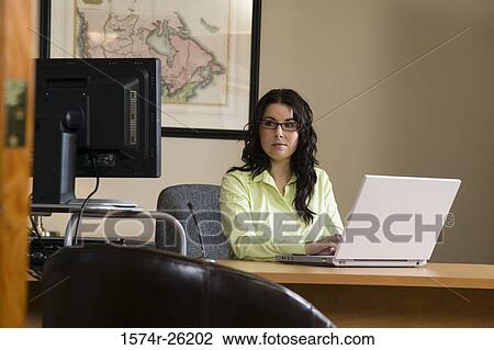 Businesswoman using a laptop View Large Photo Image Stock Image - Businesswoman using a laptop. Fotosearch