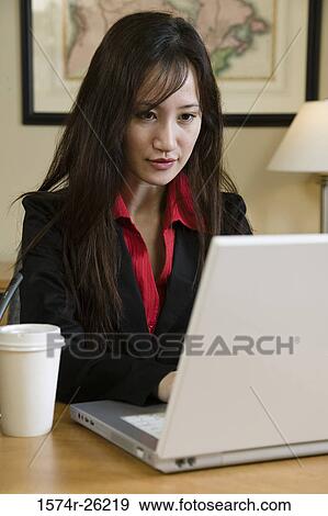 Busineswoman using a laptop View Large Photo Image Stock Photo - Busineswoman using a laptop. Fotosearch
