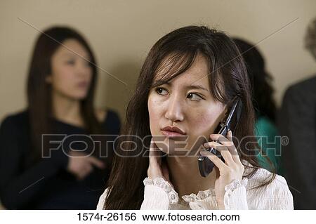Stock Photograph - Close-of a businesswoman talking on a mobile phone. Fotosearch