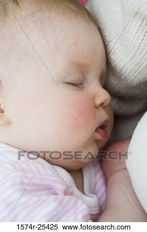 Stock Photography - Close-up of a baby girl sleeping. Fotosearch