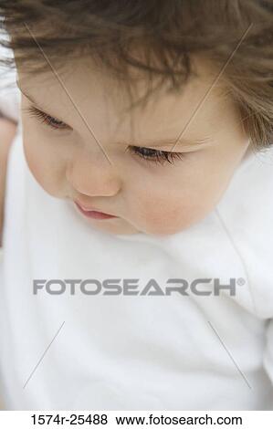 Close-up of a baby looking down View Large Photo Image Stock Photo - Close-up of a baby looking down. Fotosearch