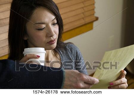 Close-up of a businesswoman being handed a document View Large Photo Image Stock Photo - Close-up of a businesswoman being handed a document. Fotosearch