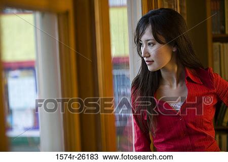 Close-up of a businesswoman looking through a window View Large Photo Image Stock Image - Close-up of a businesswoman looking through a window. Fotosearch
