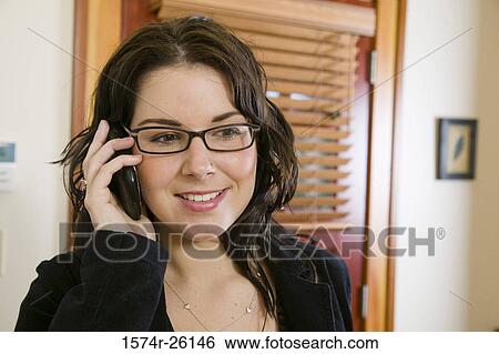 Close-up of a businesswoman talking on a mobile phone View Large Photo Image Stock Photograph - Close-up of a businesswoman talking on a mobile phone. Fotosearch