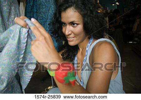Close-up of a female fashion designer working on a dress View Large Photo Image Stock Photo - Close-up of a female fashion designer working on a dress. Fotosearch