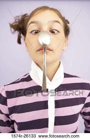 Close-up of a girl balancing a spoon on her nose View Large Photo Image Stock Image - Close-up of a girl balancing a spoon on her nose. Fotosearch