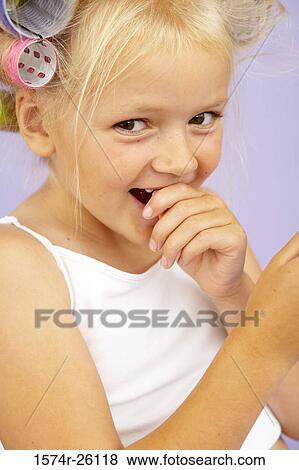 Close-up of a girl with curlers in her hair View Large Photo Image Stock Photo - Close-up of a girl with curlers in her hair. Fotosearch