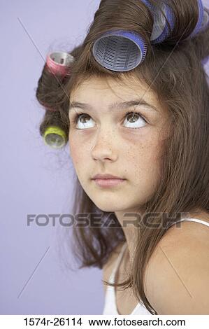 Close-up of a girl with hair curlers in her hair View Large Photo Image Picture - Close-up of a girl with hair curlers in her hair. Fotosearch