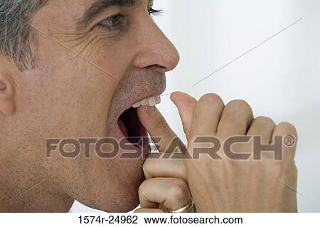 Close-up of a mature man flossing his teeth View Large Photo Image Stock Image - Close-up of a mature man flossing his teeth. Fotosearch