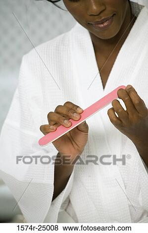 Close-up of a mature woman filing her fingernails View Large Photo Image Stock Photo - Close-up of a mature woman filing her fingernails. Fotosearch