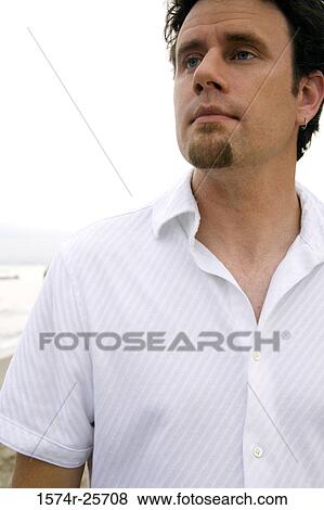 Stock Photo - Close-up of a mid adult man staring. Fotosearch