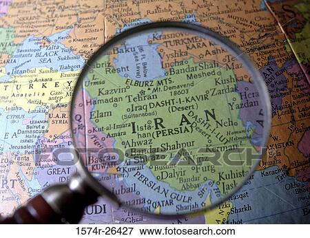 Stock Photo - Close-up of a world map viewed through a magnifying glass. Fotosearch