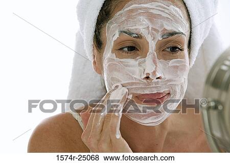 Close-up of a young adult woman applying cleanser to her face View Large Photo Image Stock Photo - Close-up of a young adult woman applying cleanser to her face. Fotosearch
