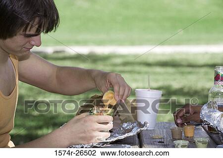 Close-up of a young man eating View Large Photo Image Stock Image - Close-up of a young man eating. Fotosearch