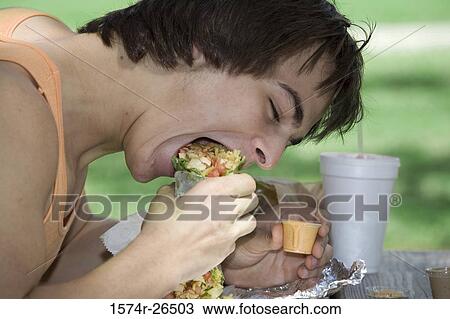 Close-up of a young man eating View Large Photo Image Stock Image - Close-up of a young man eating. Fotosearch