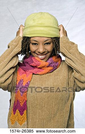 Stock Photography - Close-up of a young woman wearing a knit hat and smiling. Fotosearch