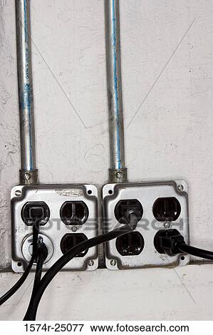 Close-up of electric plugs in power sockets View Large Photo Image Stock Photo - Close-up of electric plugs in power sockets. Fotosearch