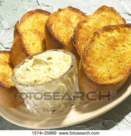 Close-up of garlic bread with a bowl of dip on a plate View Large Photo Image Stock Photo - Close-up of garlic bread with a bowl of dip on a plate. Fotosearch