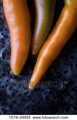 Close-up of three chili peppers View Large Photo Image Stock Image - Close-up of three chili peppers. Fotosearch